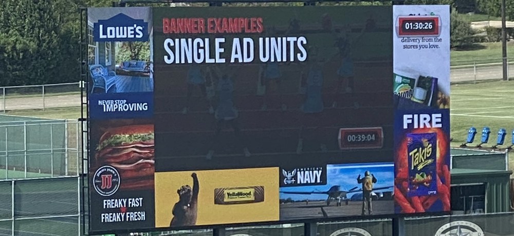 50ft by 23ft LED videoboard at Keller ISD demonstrating single-ad-unit sponsor layouts, with separate banner positions running alongside the main video window